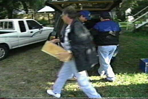 Ralph M. Barlow (foreground) stealing Kelly Benjamin's private property.